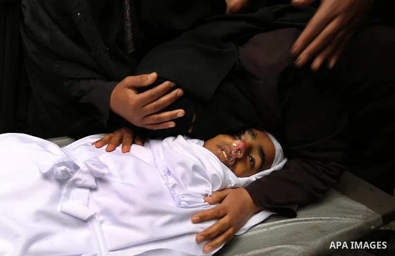 Relatives mourn around the body of Palestinian Youssef Abu Azra, who according to hospital officials was killed by Israeli fire and whom the Israeli forces said was detected with other suspects near the security fence, d...