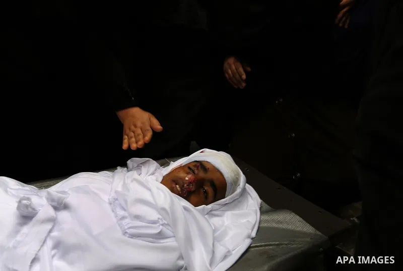 Relatives mourn around the body of Palestinian Youssef Abu Azra, who according to hospital officials was killed by Israeli fire and whom the Israeli forces said was detected with other suspects near the security fence, d...