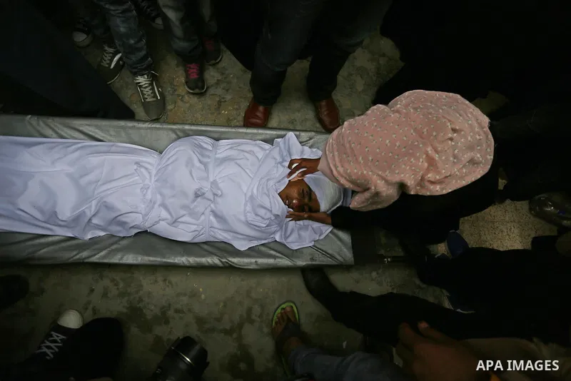 Relatives mourn around the body of Palestinian Youssef Abu Azra, who according to hospital officials was killed by Israeli fire and whom the Israeli forces said was detected with other suspects near the security fence, d...