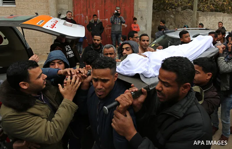 Mourners carry the body of Palestinian Youssef Abu Azra, who according to hospital officials was killed by Israeli fire and whom the Israeli forces said was detected with other suspects near the security fence, during hi...