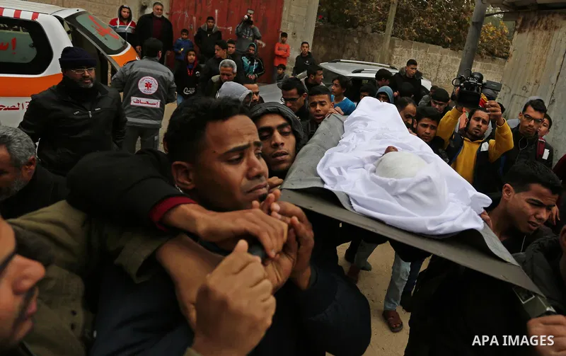 Mourners carry the body of Palestinian Youssef Abu Azra, who according to hospital officials was killed by Israeli fire and whom the Israeli forces said was detected with other suspects near the security fence, during hi...