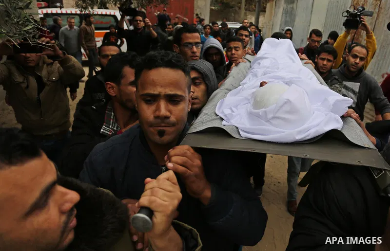 Mourners carry the body of Palestinian Youssef Abu Azra, who according to hospital officials was killed by Israeli fire and whom the Israeli forces said was detected with other suspects near the security fence, during hi...