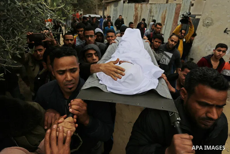 Mourners carry the body of Palestinian Youssef Abu Azra, who according to hospital officials was killed by Israeli fire and whom the Israeli forces said was detected with other suspects near the security fence, during hi...