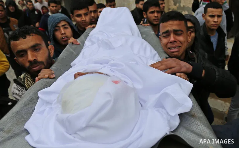 Mourners carry the body of Palestinian Youssef Abu Azra, who according to hospital officials was killed by Israeli fire and whom the Israeli forces said was detected with other suspects near the security fence, during hi...