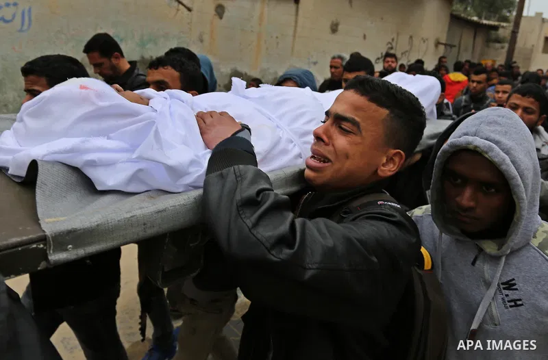 Mourners carry the body of Palestinian Youssef Abu Azra, who according to hospital officials was killed by Israeli fire and whom the Israeli forces said was detected with other suspects near the security fence, during hi...