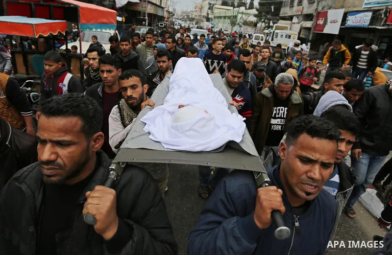 Mourners carry the body of Palestinian Youssef Abu Azra, who according to hospital officials was killed by Israeli fire and whom the Israeli forces said was detected with other suspects near the security fence, during hi...