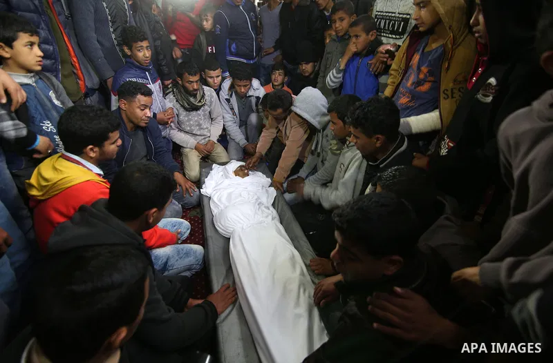 Relatives mourn around the body of Palestinian Youssef Abu Azra, who according to hospital officials was killed by Israeli fire and whom the Israeli forces said was detected with other suspects near the security fence, d...