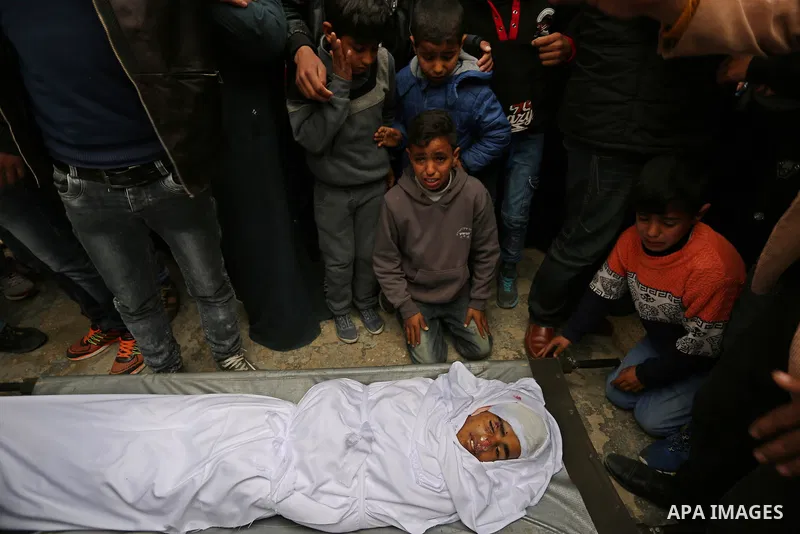 Relatives mourn around the body of Palestinian Youssef Abu Azra, who according to hospital officials was killed by Israeli fire and whom the Israeli forces said was detected with other suspects near the security fence, d...
