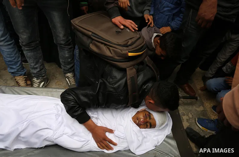 Relatives mourn around the body of Palestinian Youssef Abu Azra, who according to hospital officials was killed by Israeli fire and whom the Israeli forces said was detected with other suspects near the security fence, d...