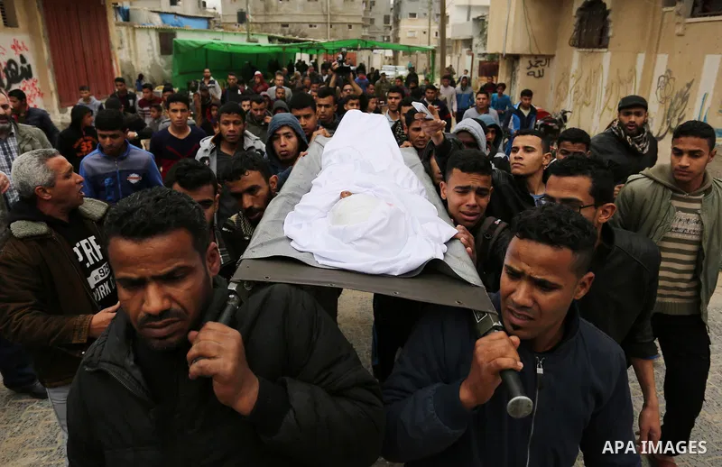 Mourners carry the body of Palestinian Youssef Abu Azra, who according to hospital officials was killed by Israeli fire and whom the Israeli forces said was detected with other suspects near the security fence, during hi...