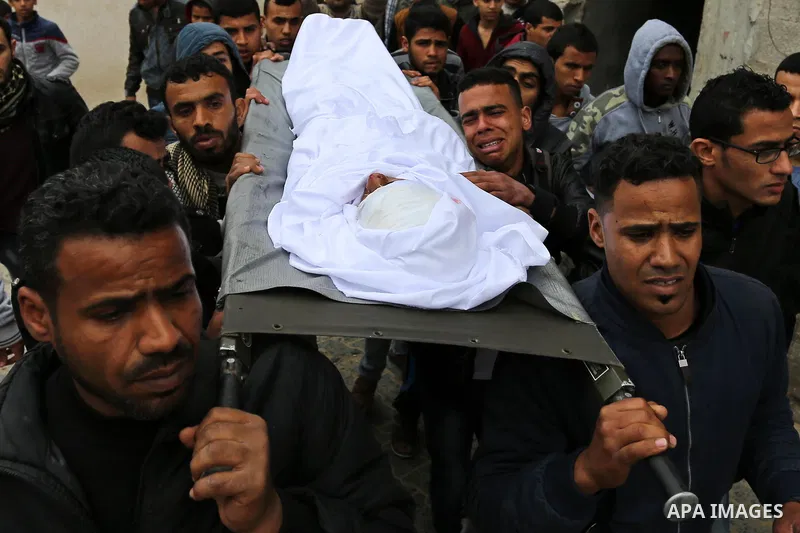 Mourners carry the body of Palestinian Youssef Abu Azra, who according to hospital officials was killed by Israeli fire and whom the Israeli forces said was detected with other suspects near the security fence, during hi...