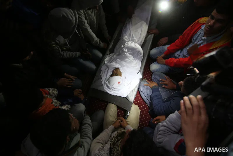 Relatives mourn around the body of Palestinian Youssef Abu Azra, who according to hospital officials was killed by Israeli fire and whom the Israeli forces said was detected with other suspects near the security fence, d...