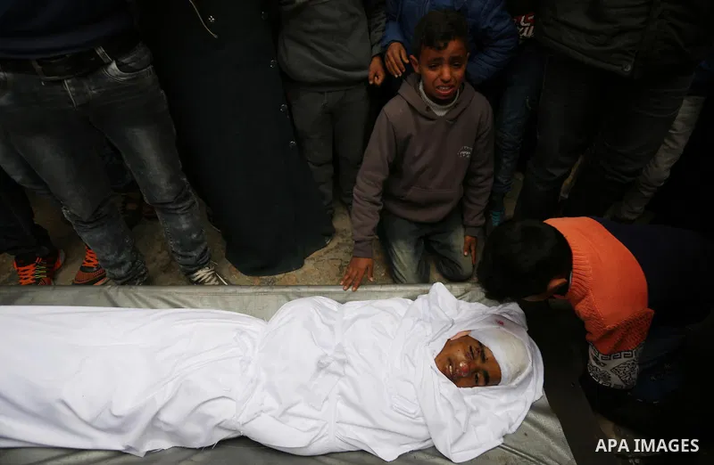 Relatives mourn around the body of Palestinian Youssef Abu Azra, who according to hospital officials was killed by Israeli fire and whom the Israeli forces said was detected with other suspects near the security fence, d...