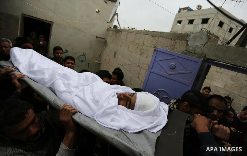 Mourners carry the body of Palestinian Youssef Abu Azra, who according to hospital officials was killed by Israeli fire and whom the Israeli forces said was detected with other suspects near the security fence, during hi...