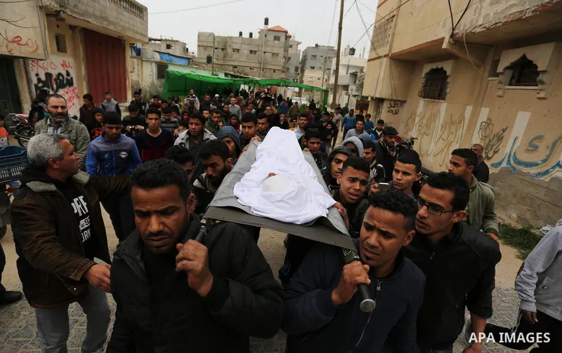 Mourners carry the body of Palestinian Youssef Abu Azra, who according to hospital officials was killed by Israeli fire and whom the Israeli forces said was detected with other suspects near the security fence, during hi...