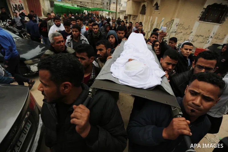 Mourners carry the body of Palestinian Youssef Abu Azra, who according to hospital officials was killed by Israeli fire and whom the Israeli forces said was detected with other suspects near the security fence, during hi...