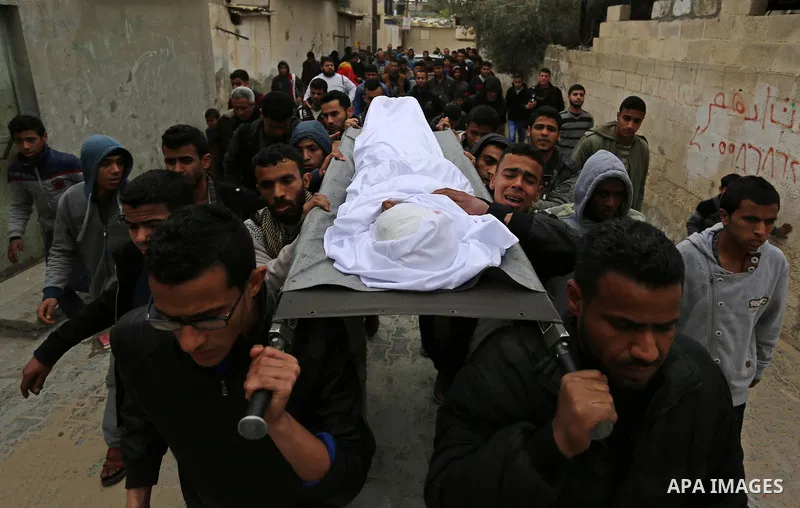 Mourners carry the body of Palestinian Youssef Abu Azra, who according to hospital officials was killed by Israeli fire and whom the Israeli forces said was detected with other suspects near the security fence, during hi...