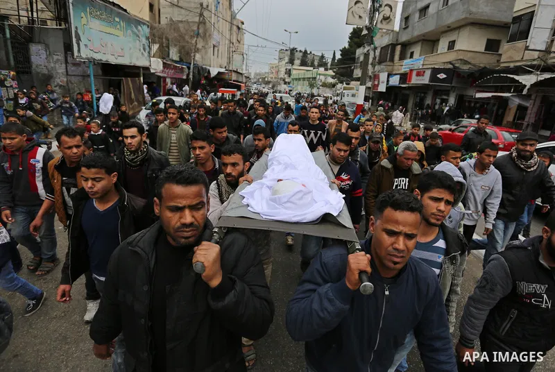 Mourners carry the body of Palestinian Youssef Abu Azra, who according to hospital officials was killed by Israeli fire and whom the Israeli forces said was detected with other suspects near the security fence, during hi...