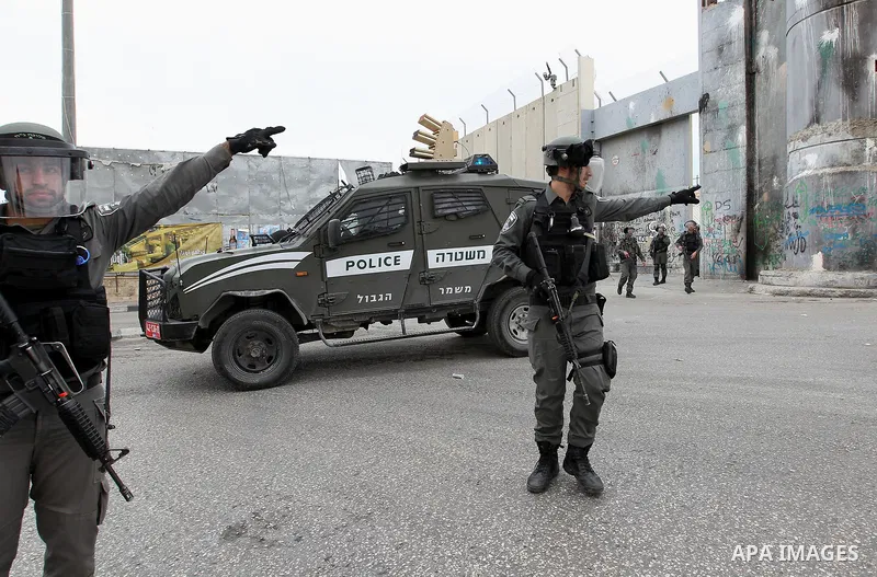 Israeli border policemen take position during clashes with Palestinians following a protest to demand the return of bodies of Palestinians who were allegedly involved in attacks and consequently killed by Israeli forces...