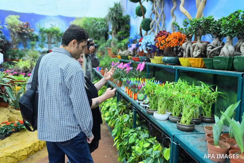 Egyptians attend the Spring flowers exhibition at the Orman Garden, in Cairo, Egypt, on March 24, 2017. Photo by Amr Sayed