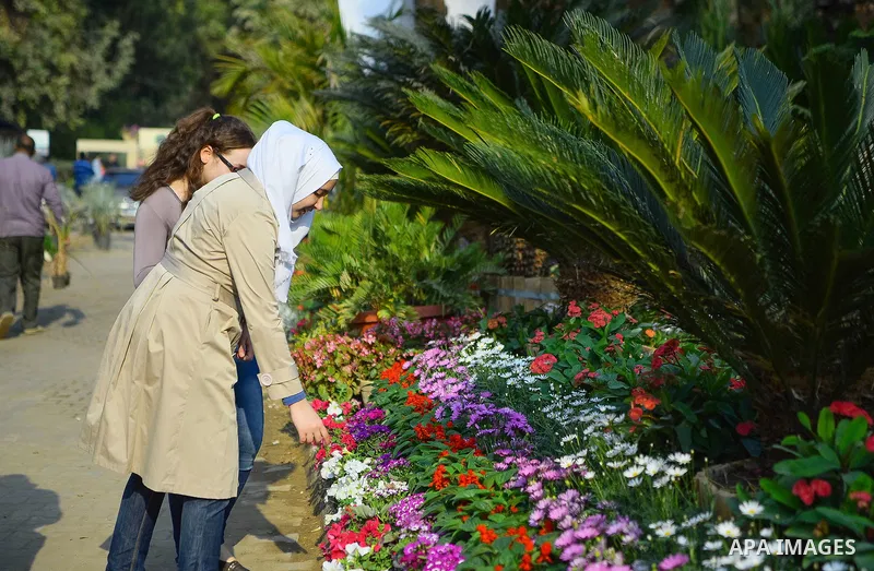 Egyptians attend the Spring flowers exhibition at the Orman Garden, in Cairo, Egypt, on March 24, 2017. Photo by Amr Sayed
