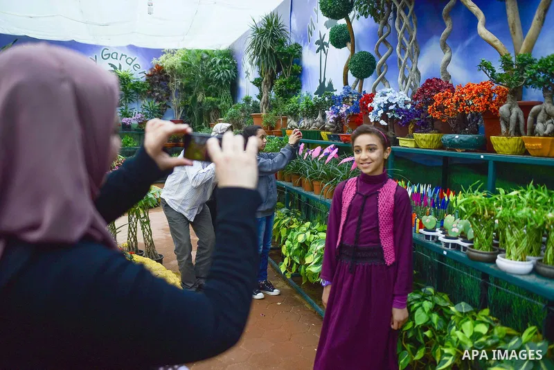 Egyptians attend the Spring flowers exhibition at the Orman Garden, in Cairo, Egypt, on March 24, 2017. Photo by Amr Sayed