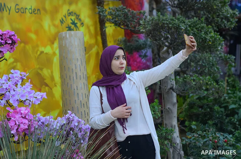 Egyptians attend the Spring flowers exhibition at the Orman Garden, in Cairo, Egypt, on March 24, 2017. Photo by Amr Sayed
