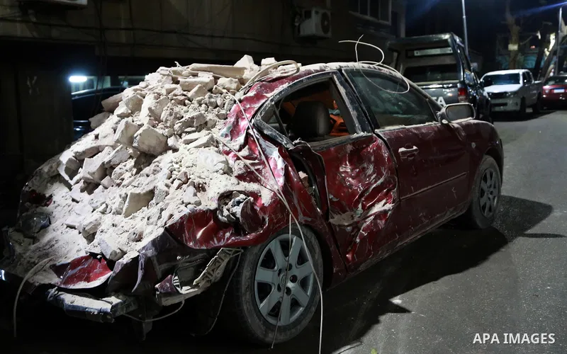 A damaged car is seen in front of the collapsed building in Garden City area in downtown Cairo on March 25, 2017. Photo by Amr Sayed