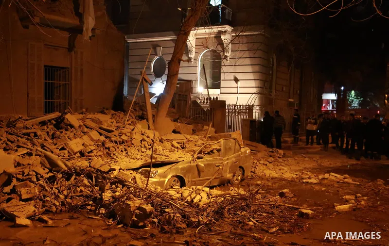 A damaged car is seen in front of the collapsed building in Garden City area in downtown Cairo on March 25, 2017. Photo by Amr Sayed