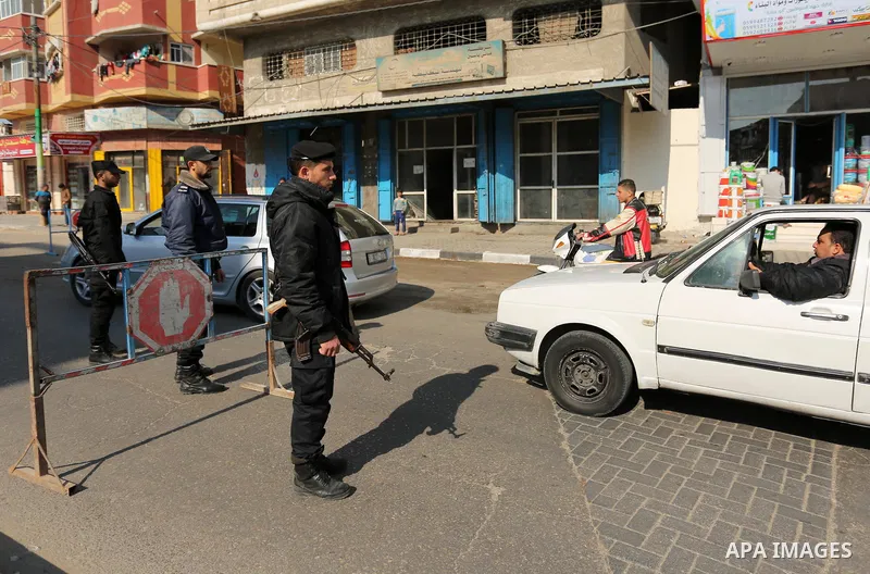 Palestinian police officers inspect cars at a checkpoint in Gaza City on March 25, 2017. Photo by Ashraf Amra