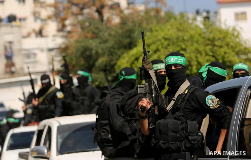 Members of the Ezzedine al-Qassam Brigades, the military wing of the Palestinian Islamist movement Hamas take part in the funeral of Hamas official, Mazen Faqha who was freed by Israel in a 2011 prisoner swap in Gaza Cit...