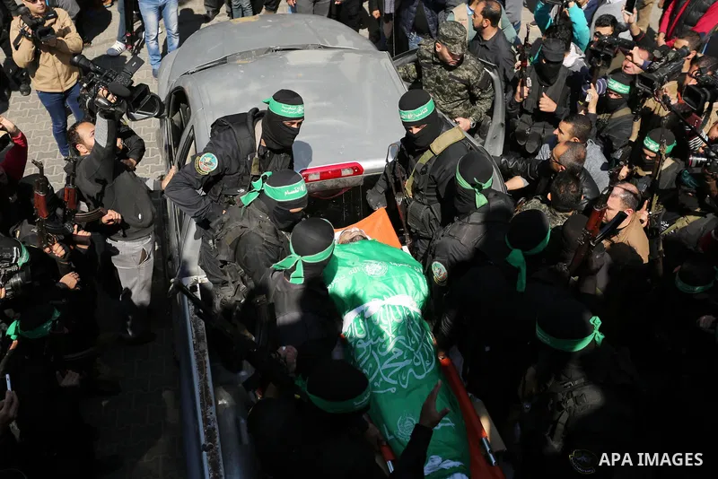 Members of the Ezzedine al-Qassam Brigades, the military wing of the Palestinian Islamist movement Hamas carry the body of Hamas official, Mazen Faqha who was freed by Israel in a 2011 prisoner swap during his funeral in...