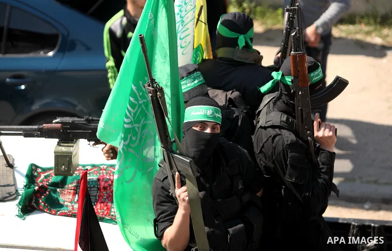 Members of the Ezzedine al-Qassam Brigades, the military wing of the Palestinian Islamist movement Hamas take part in the funeral of Hamas official, Mazen Faqha who was freed by Israel in a 2011 prisoner swap in Gaza Cit...