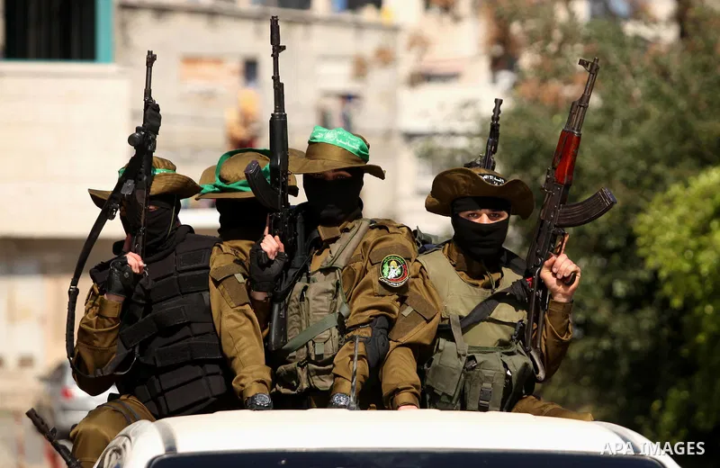 Members of the Ezzedine al-Qassam Brigades, the military wing of the Palestinian Islamist movement Hamas take part in the funeral of Hamas official, Mazen Faqha who was freed by Israel in a 2011 prisoner swap in Gaza Cit...