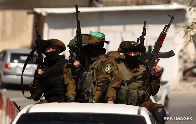 Members of the Ezzedine al-Qassam Brigades, the military wing of the Palestinian Islamist movement Hamas take part in the funeral of Hamas official, Mazen Faqha who was freed by Israel in a 2011 prisoner swap in Gaza Cit...