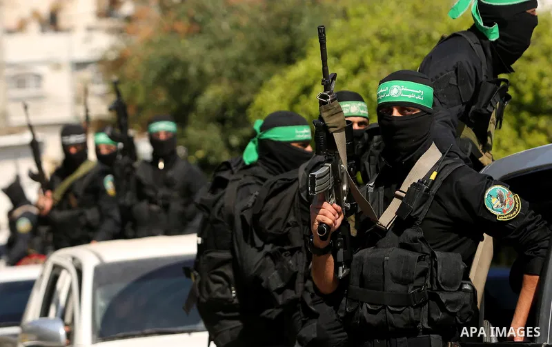 Members of the Ezzedine al-Qassam Brigades, the military wing of the Palestinian Islamist movement Hamas take part in the funeral of Hamas official, Mazen Faqha who was freed by Israel in a 2011 prisoner swap in Gaza Cit...