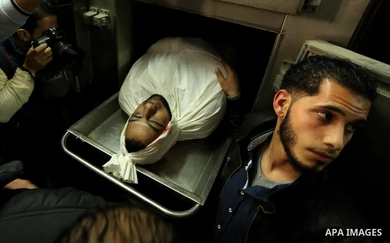 A Palestinian man looks at the body of of Hamas official, Mazen Faqha who was freed by Israel in a 2011 prisoner swap at a hospital morgue in Gaza City March 25, 2017. Faqha was released along with more than 1,000 other...
