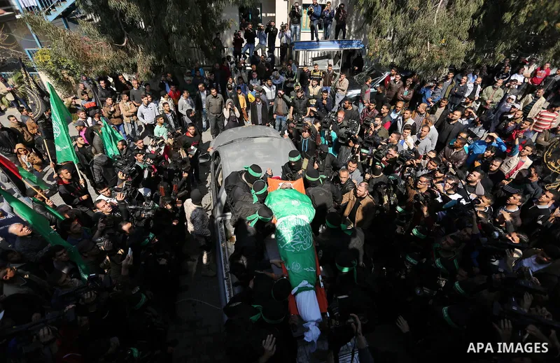 Members of the Ezzedine al-Qassam Brigades, the military wing of the Palestinian Islamist movement Hamas carry the body of Hamas official, Mazen Faqha who was freed by Israel in a 2011 prisoner swap during his funeral in...