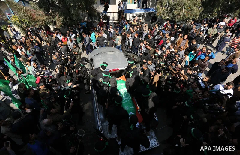 Members of the Ezzedine al-Qassam Brigades, the military wing of the Palestinian Islamist movement Hamas carry the body of Hamas official, Mazen Faqha who was freed by Israel in a 2011 prisoner swap during his funeral in...