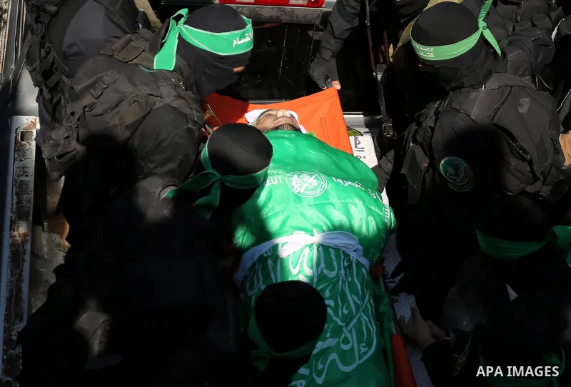 Members of the Ezzedine al-Qassam Brigades, the military wing of the Palestinian Islamist movement Hamas carry the body of Hamas official, Mazen Faqha who was freed by Israel in a 2011 prisoner swap during his funeral in...