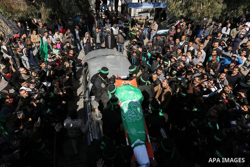 Members of the Ezzedine al-Qassam Brigades, the military wing of the Palestinian Islamist movement Hamas carry the body of Hamas official, Mazen Faqha who was freed by Israel in a 2011 prisoner swap during his funeral in...