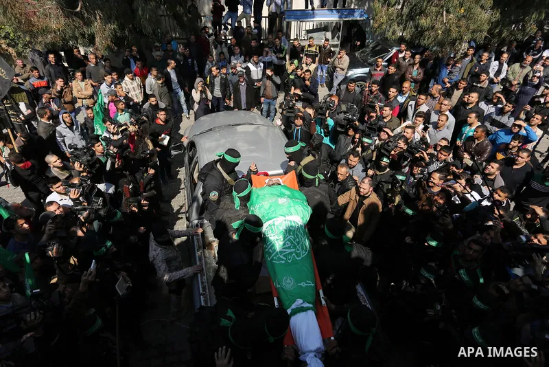 Members of the Ezzedine al-Qassam Brigades, the military wing of the Palestinian Islamist movement Hamas carry the body of Hamas official, Mazen Faqha who was freed by Israel in a 2011 prisoner swap during his funeral in...