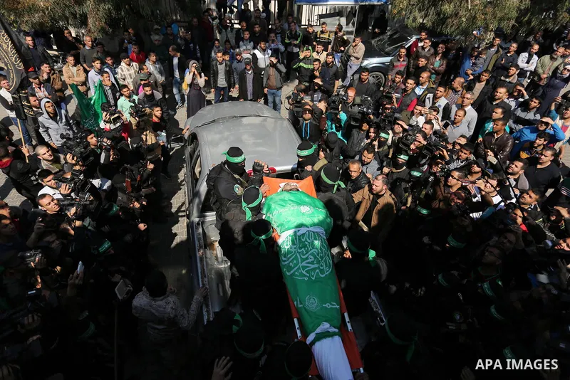 Members of the Ezzedine al-Qassam Brigades, the military wing of the Palestinian Islamist movement Hamas carry the body of Hamas official, Mazen Faqha who was freed by Israel in a 2011 prisoner swap during his funeral in...