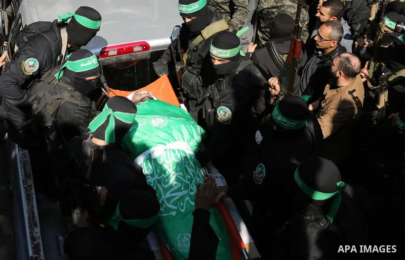 Members of the Ezzedine al-Qassam Brigades, the military wing of the Palestinian Islamist movement Hamas carry the body of Hamas official, Mazen Faqha who was freed by Israel in a 2011 prisoner swap during his funeral in...