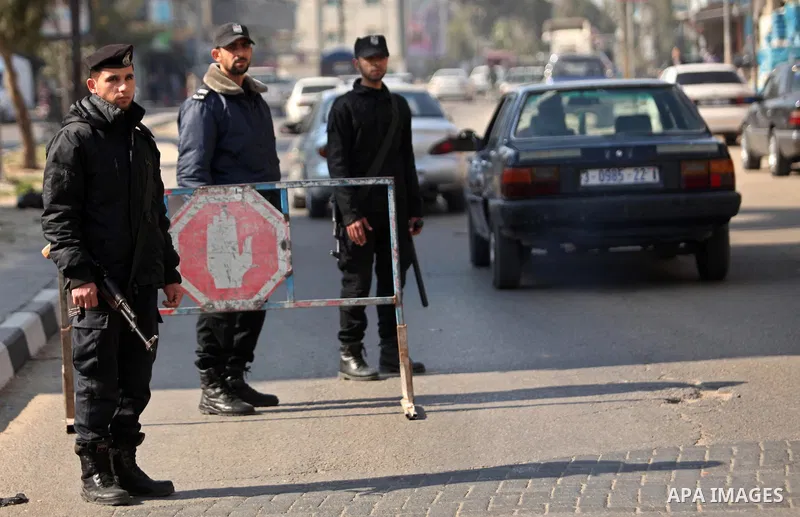 Palestinian police officers inspect cars at a checkpoint in Gaza City on March 25, 2017. Photo by Ashraf Amra