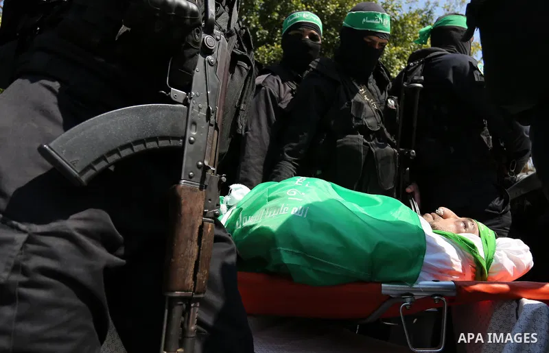Members of the Ezzedine al-Qassam Brigades, the military wing of the Palestinian Islamist movement Hamas carry the body of Hamas official, Mazen Faqha who was freed by Israel in a 2011 prisoner swap during his funeral in...