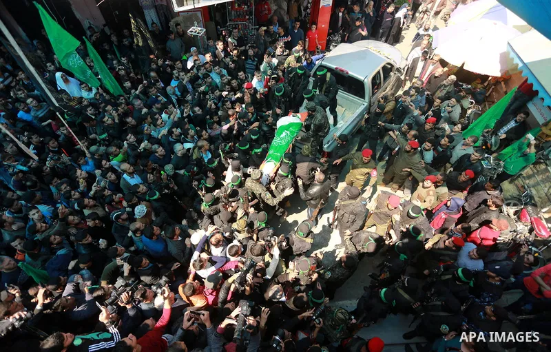 Members of the Ezzedine al-Qassam Brigades, the military wing of the Palestinian Islamist movement Hamas carry the body of Hamas official, Mazen Faqha who was freed by Israel in a 2011 prisoner swap during his funeral in...
