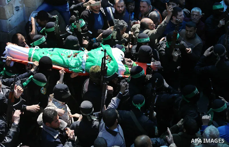 Members of the Ezzedine al-Qassam Brigades, the military wing of Hamas carry the body of Palestinian Islamist movement Hamas' official Mazen Faqha, during his funeral in Gaza city on March 25, 2017. Gunmen in the Gaza St...