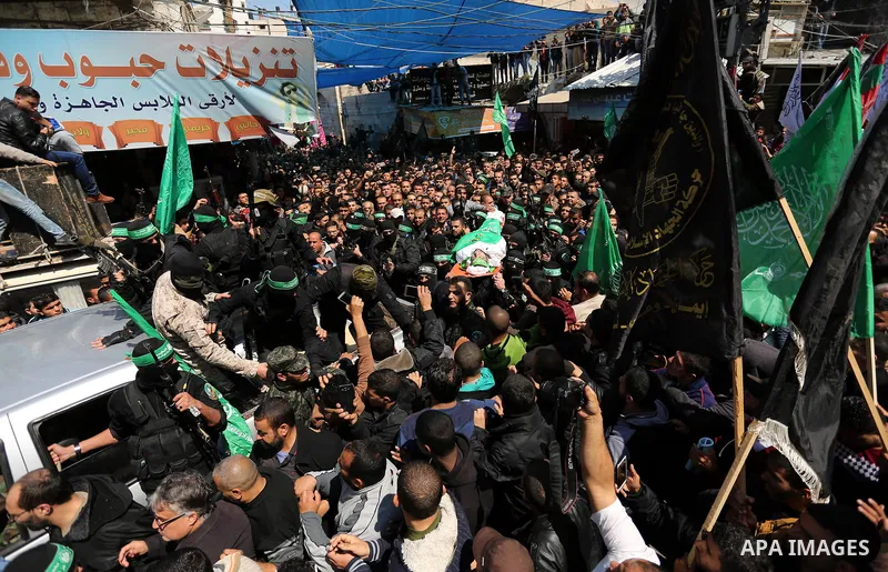 Members of the Ezzedine al-Qassam Brigades, the military wing of Hamas carry the body of Palestinian Islamist movement Hamas' official Mazen Faqha, during his funeral in Gaza city on March 25, 2017. Gunmen in the Gaza St...