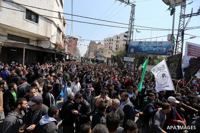 Palestinians take part in the funeral of Palestinian Islamist movement Hamas' official Mazen Faqha, in Gaza city on March 25, 2017. Gunmen in the Gaza Strip had shot dead the Hamas official on March 24, 2017, according t...